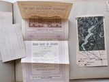 an open book with a bunch of papers on top of it
