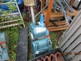 a blue machine that is sitting next to a pile of junk