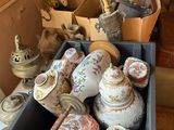 a box full of antique vases on a table