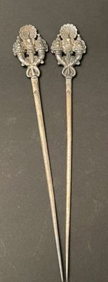 pair of antique silverware spoons with a lion head on them