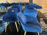 many blue chairs sitting in a row in a room