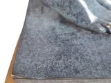 a statue of a cat that is sitting on top of a book