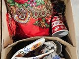 a cardboard box filled with assorted pieces of clothing