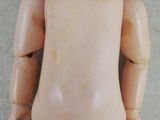 a close up of a doll with a brown hair