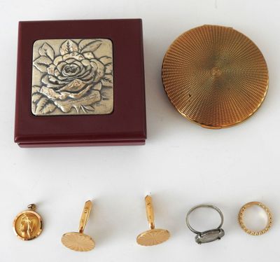 a box that has a ring, ring holder, and other items on it