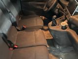 the interior of a car with the front seats down and a steering wheel in the center
