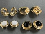 six pairs of gold tone and black and white rings
