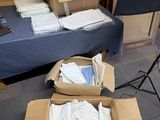 many boxes of clothing sitting on the floor next to a camera