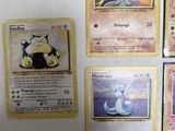 four pokemon cards on a white surface one has a cat, one has a mouse, one has a cat, and one has a mouse