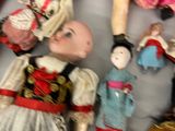 a lot of dolls that are laying on a table
