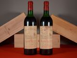 two bottles of wine sitting on top of a table next to a wooden box