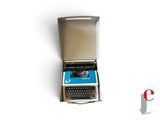an old typewriter sitting in a box on a white surface