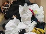 une boîte remplie de vêtements, avec un ours en peluche à l'intérieur