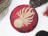 a red plate with a white flower on it next to other items