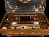 a wooden box with a writing set inside of it