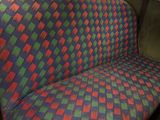 a seat in the back of a car with a checkered seat cover