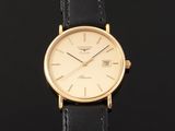 a close up of a gold wrist watch on a black background