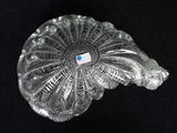 a clear glass object with a blue button on it