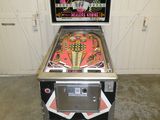 un flipper qui se trouve dans un garage