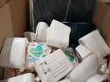 a cardboard box full of diapers and other items in it