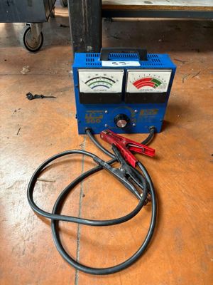 a close up of a blue machine on a wooden floor