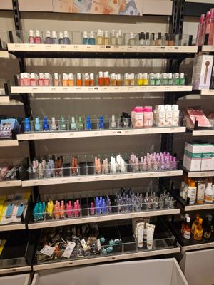 many bottles of nail polish on the shelves in the store
