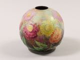 a small vase with a painted flower design on it
