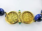 gold and lapis beaded necklace with two gold coins and a green bead