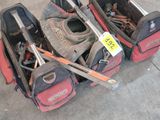 three lawn mowers that are laying on the ground