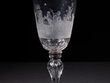 a wine glass with a pattern on it sitting on a table