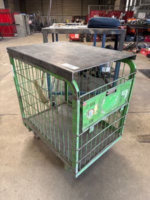 a metal cage with a green box inside of it
