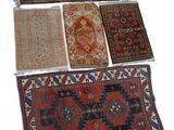 several oriental rugs are arranged in a row on a white surface