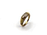 a close up of a gold ring with diamonds on a white background