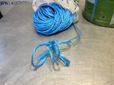 a ball of blue yarn on a table next to a can of soda