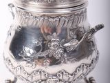 a silver container with a bird on top of it