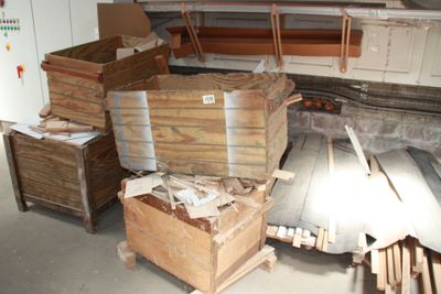 a lot of wood in a room with a lot of boxes on the floor