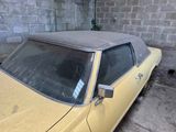 a yellow car that is parked in a garage