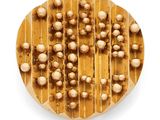 an overhead view of a cookie with nuts on it on a white background