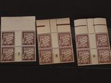 three stamps are sitting on top of each other on a black surface
