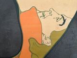a painting on the wall of a building with a woman laying on the ground