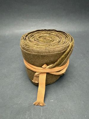 an image of a roll of brown fabric with a brown ribbon tied to it