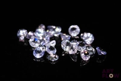 a close up of a bunch of diamonds on a black surface
