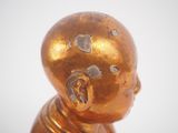 a gold statue of a person with a broken head