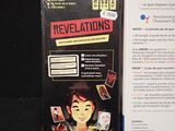 a box with a card game on it next to a box of cards