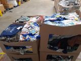 boxes of clothing are stacked on top of each other in a warehouse