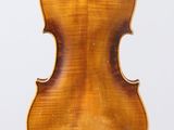 an antique violin with a wooden back and bow on a white background