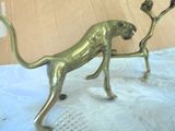 a statue of a cat with a bird on its back