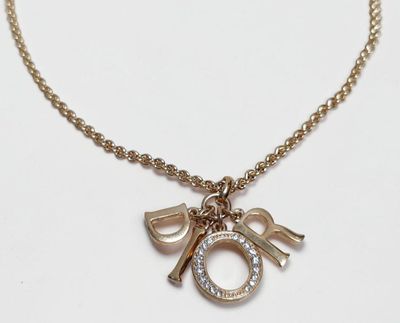 gold plated necklace with a charm and a letter o on a chain