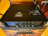 a guitar amp sitting on top of a wooden table
