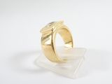 a close up of a gold ring with a diamond on it
